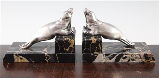 A pair of French Art Deco silvered bronze and marble seal bookends, 6in.